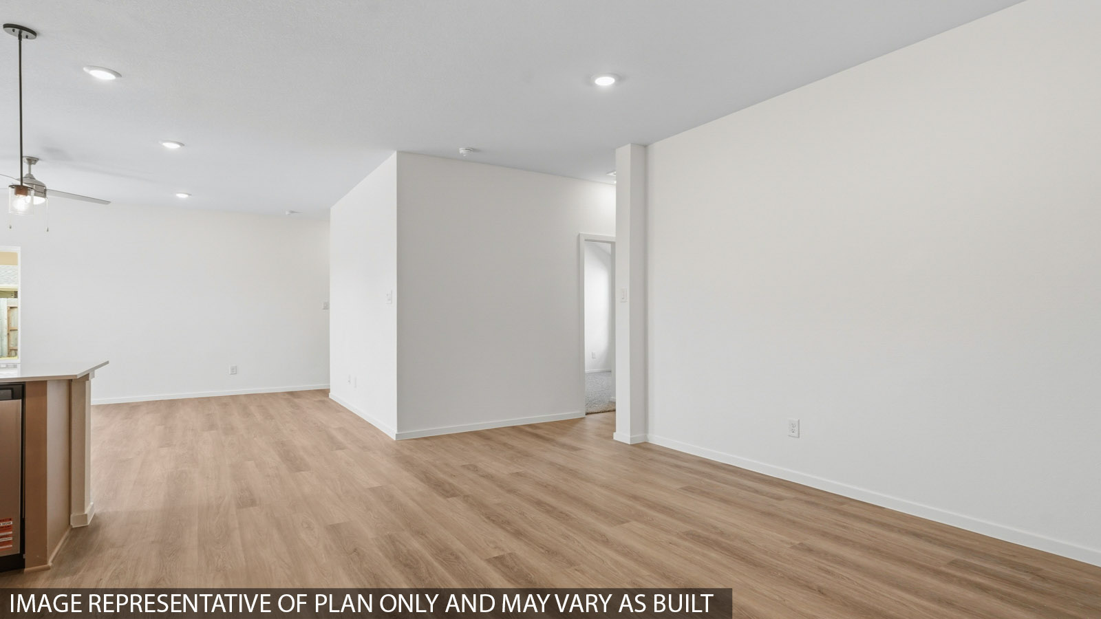 Open living room with white walls, windows, and vinyl wood flooring.