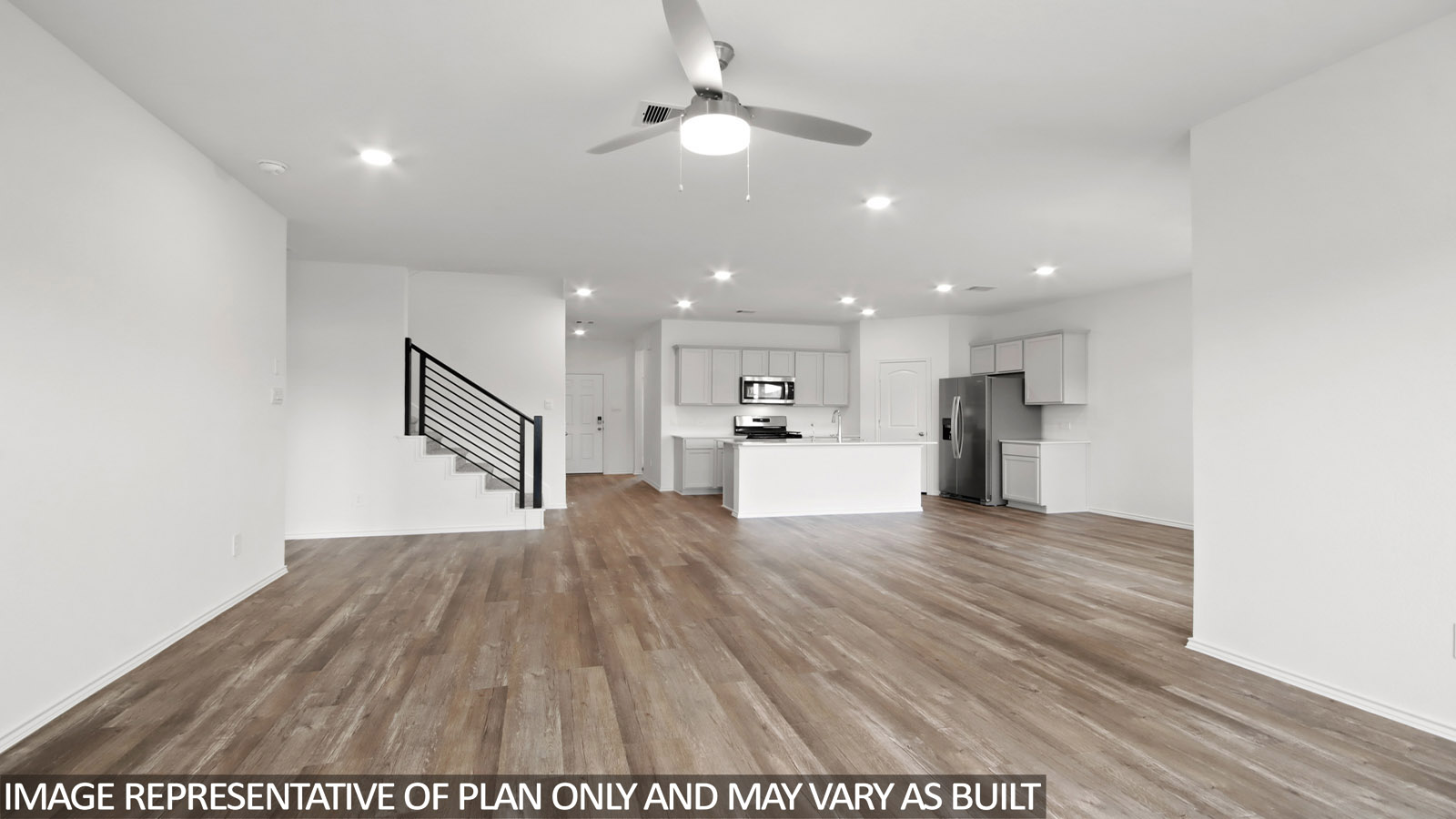 Open living room with windows, white walls, and vinyl wood flooring.