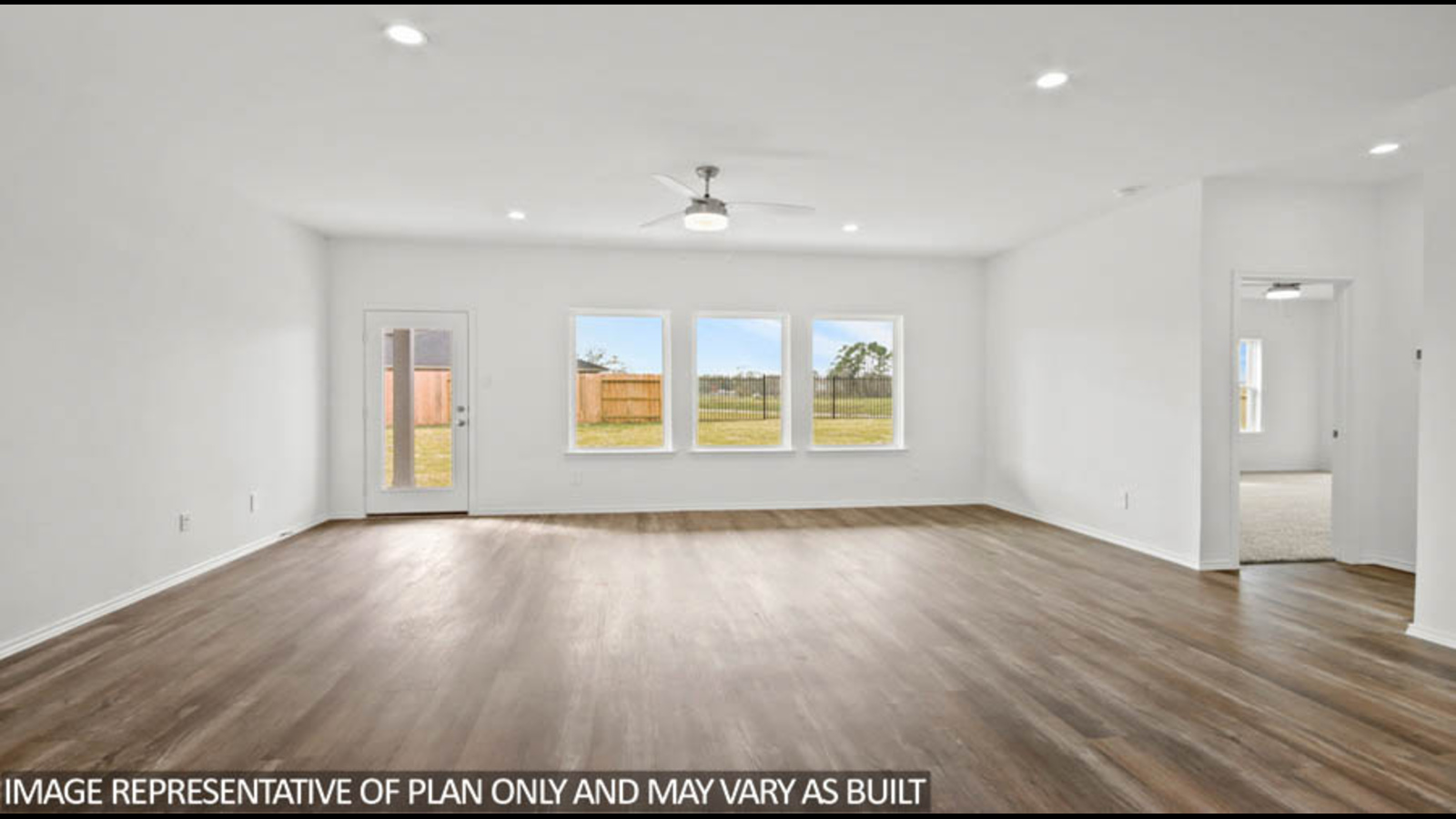 Open living room with white walls, windows, and vinyl wood flooring.