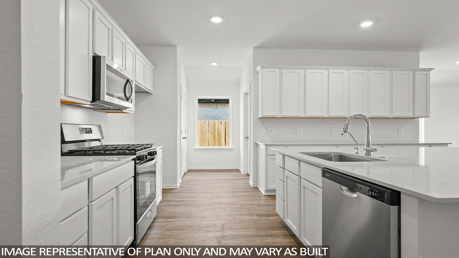 Open kitchen with an island, stainless steel appliances, white cabinets, whtie walls, and vinyl wood flooring.