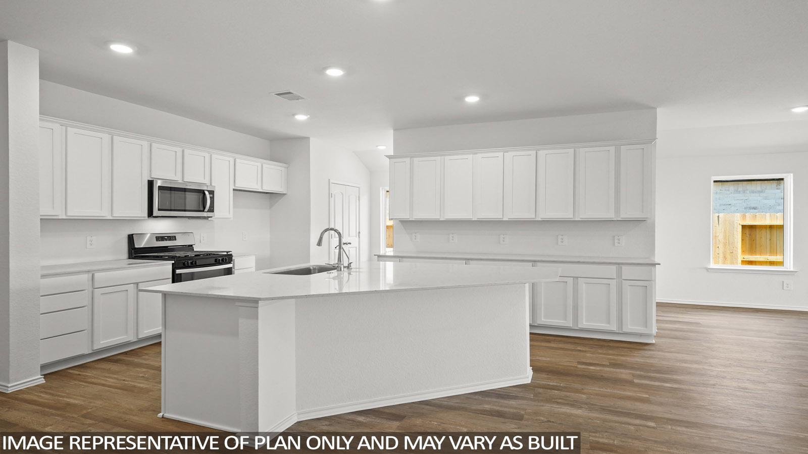 Open kitchen with an island, stainless steel appliances, white cabinets, whtie walls, and vinyl wood flooring.