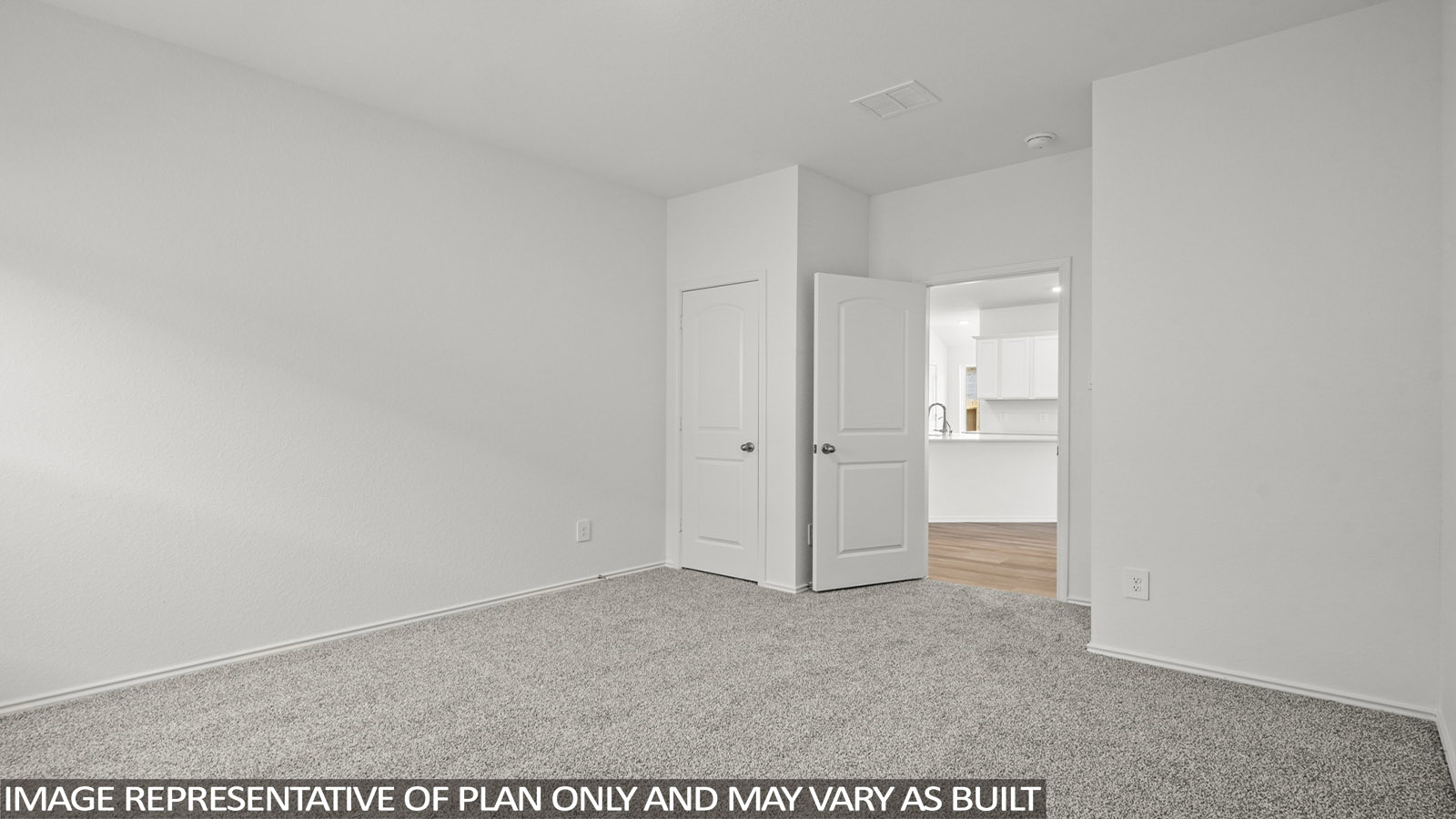 Secondary bedroom with windows, white walls, and light carpet.