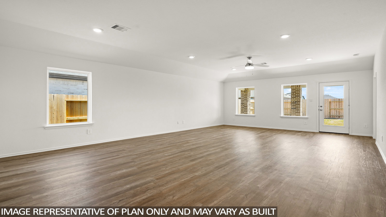 Open living room with windows, white walls, and vinyl wood flooring.
