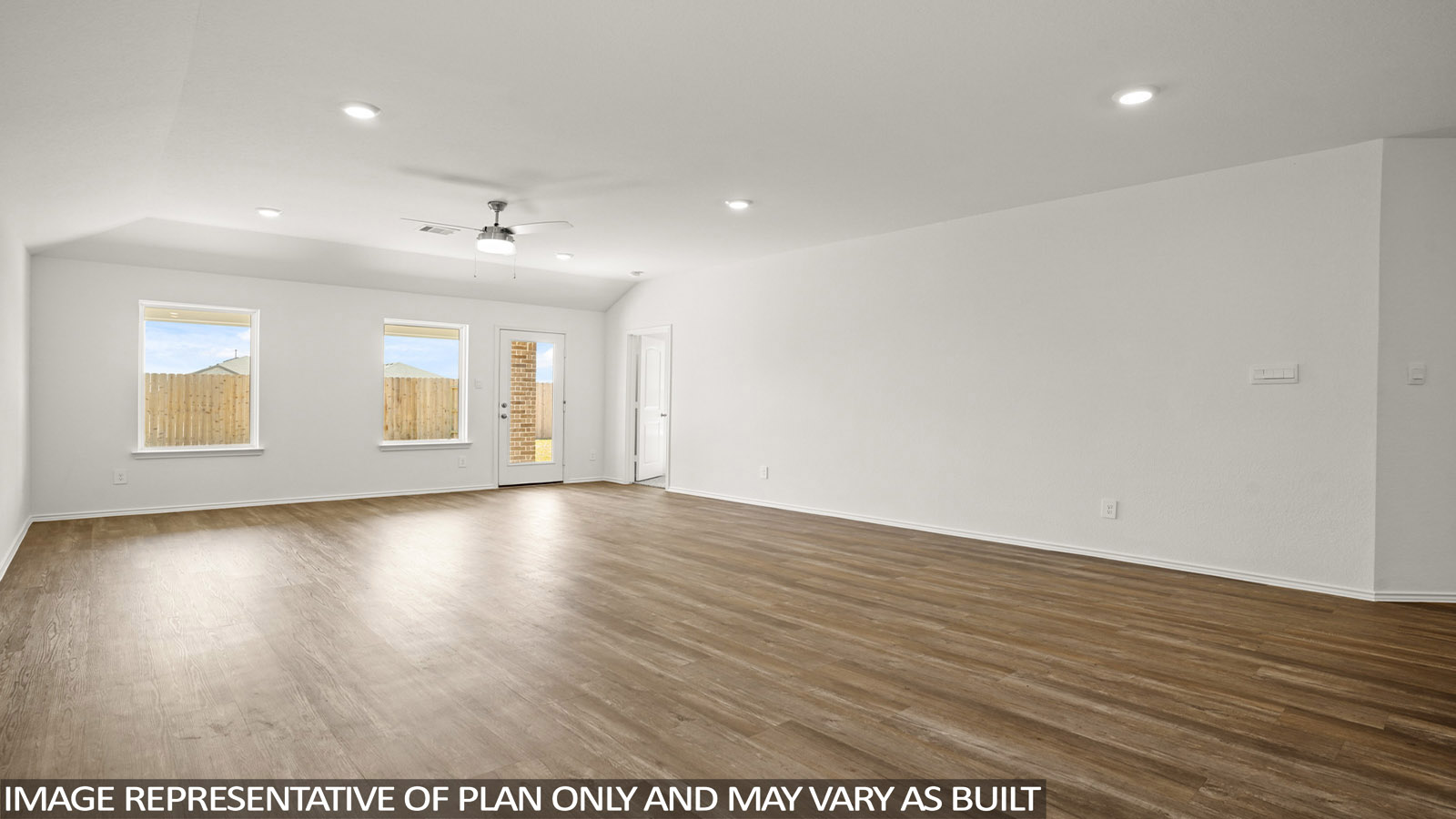 Open living room with windows, white walls, and vinyl wood flooring.