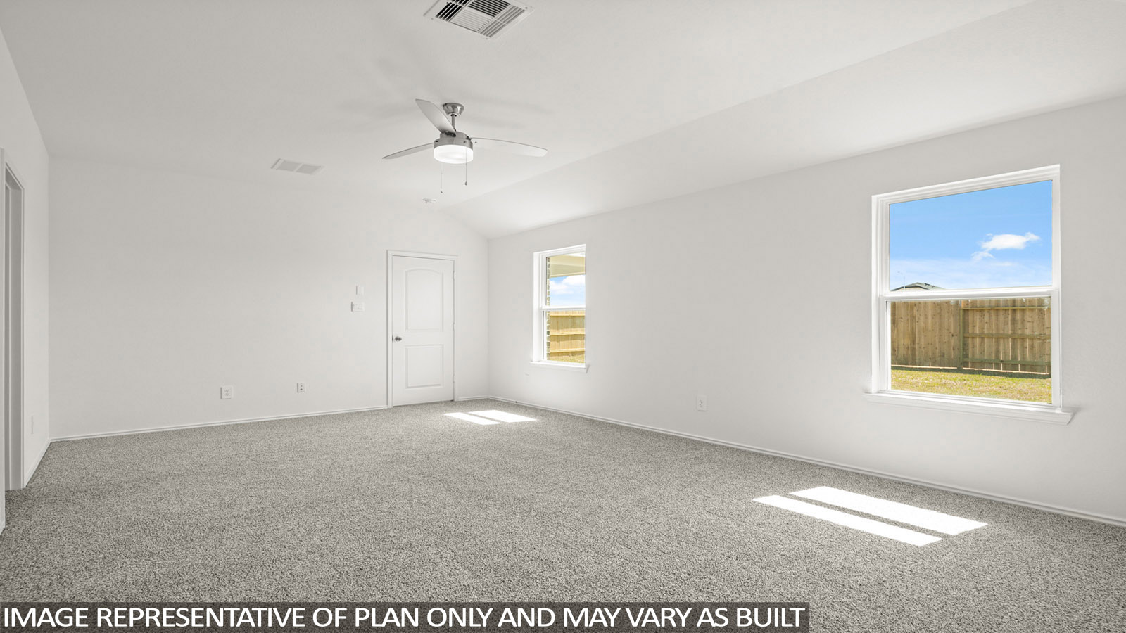 Primary bedroom with windows, white walls, and light carpet.