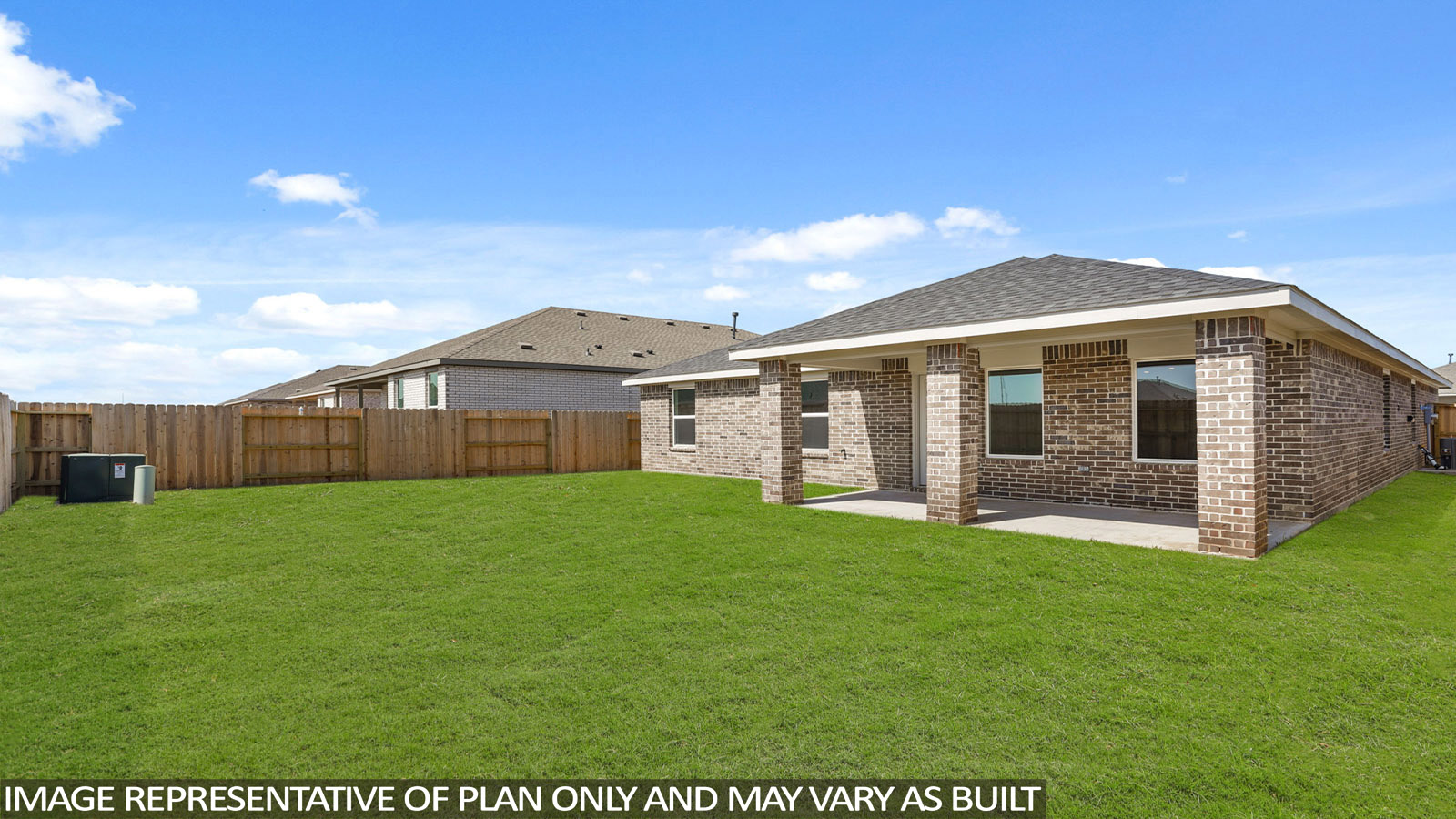 Landscaped backyard with a covered patio.