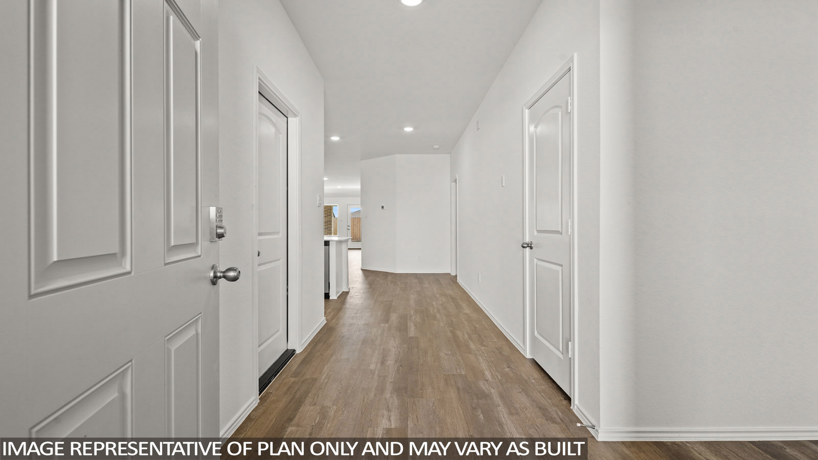 Entry hallway with white walls and vinyl wood flooring.