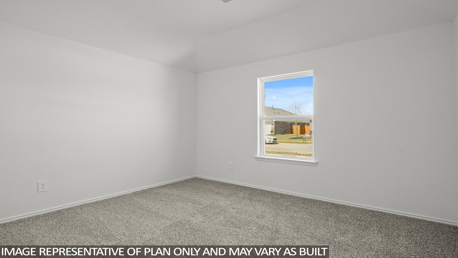 Secondary bedroom with windows, white walls, and light carpet.
