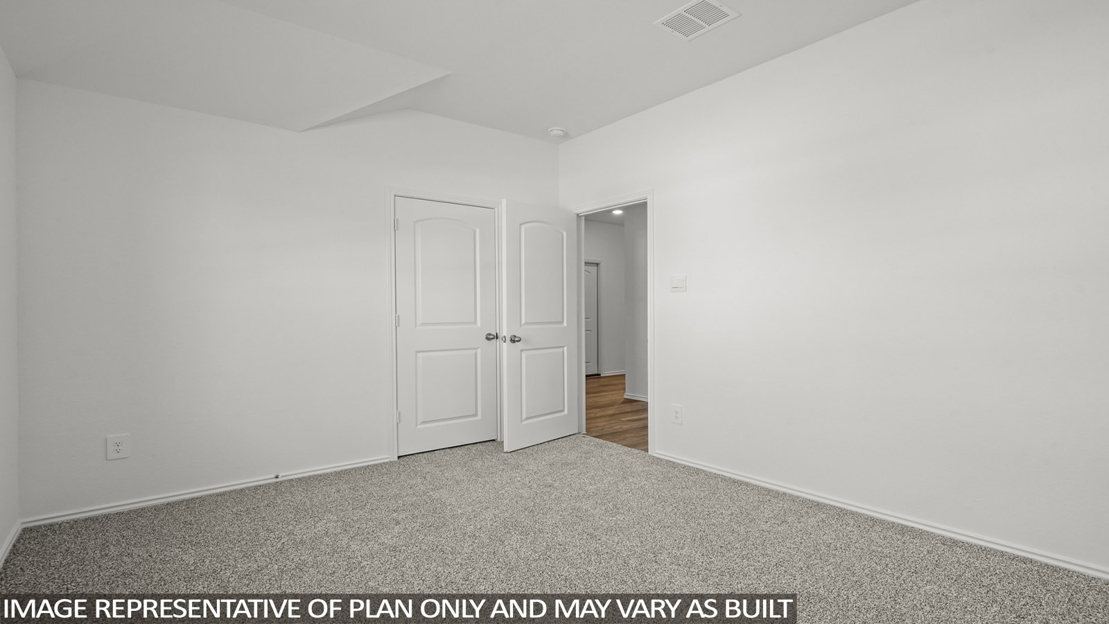 Secondary bedroom with windows, white walls, and light carpet.
