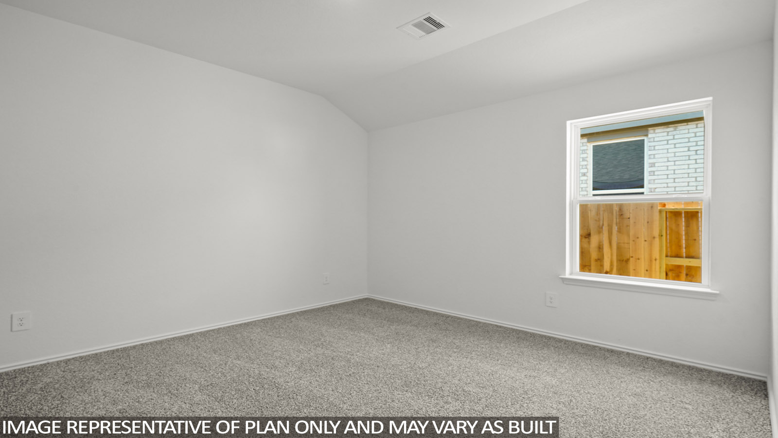 Secondary bedroom with windows, white walls, and light carpet.