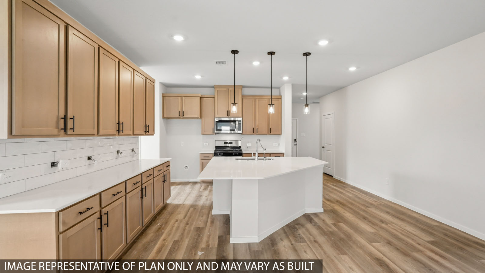 Open kitchen with an island, stainless steel appliances, white cabinets, whtie walls, and vinyl wood flooring.