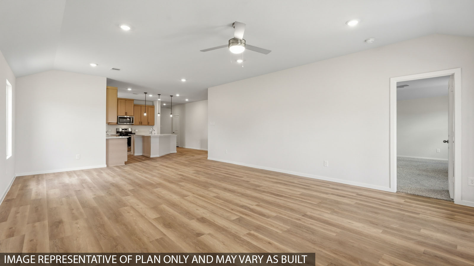 Open living room with windows, white walls, and vinyl wood flooring.