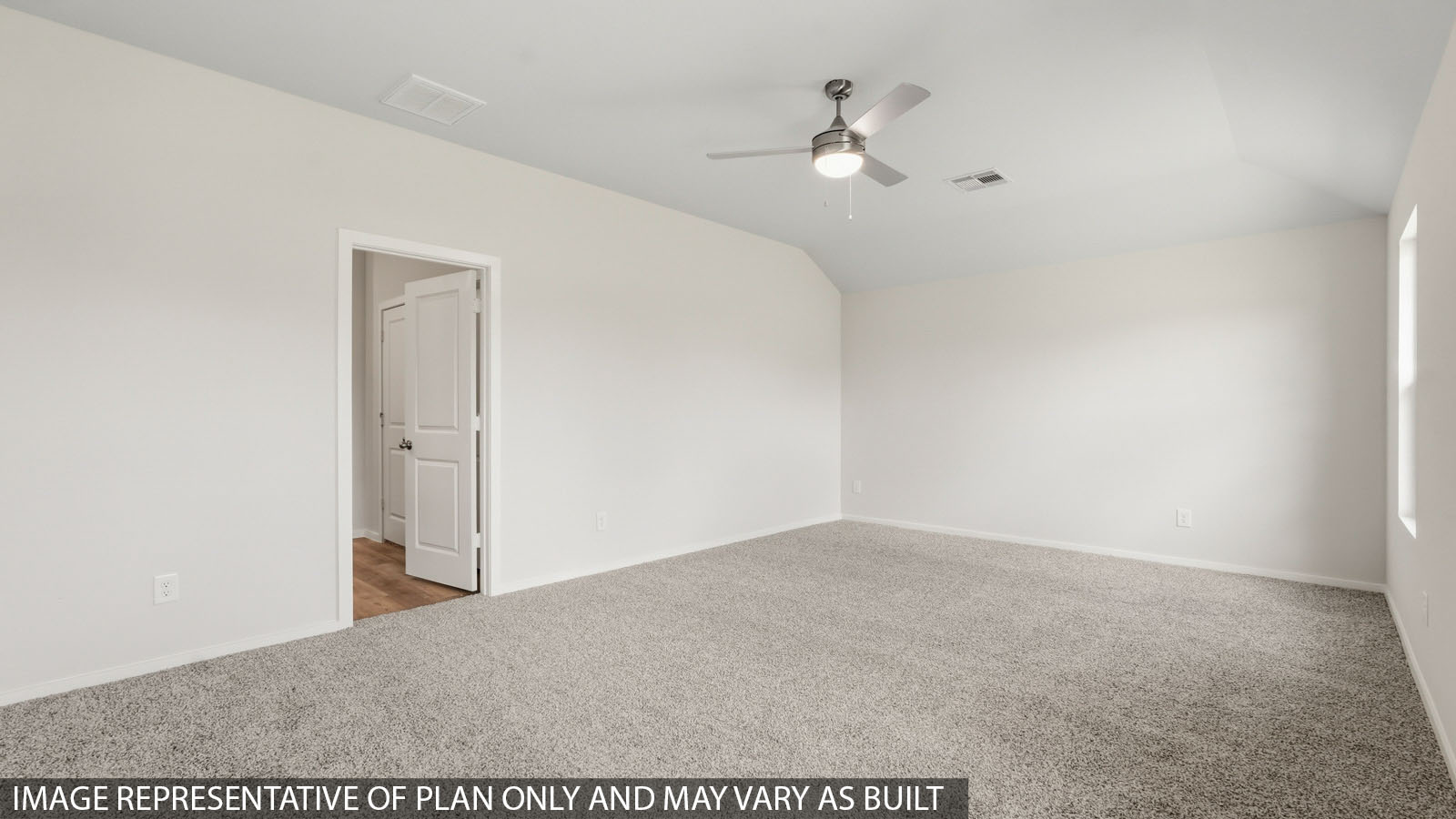Primary bedroom with windows, white walls, and light carpet.