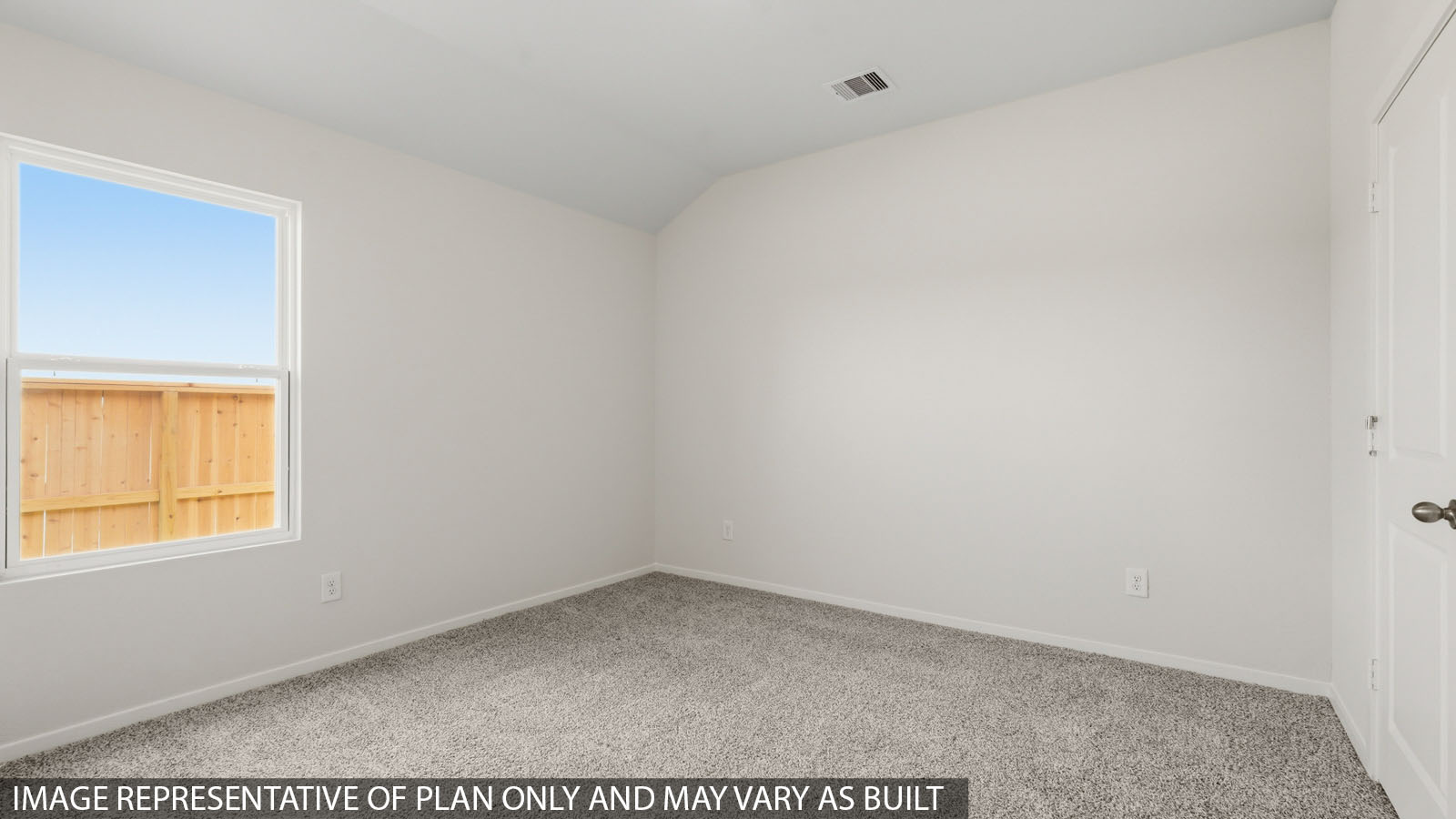 Secondary bedroom with windows, white walls, and light carpet.