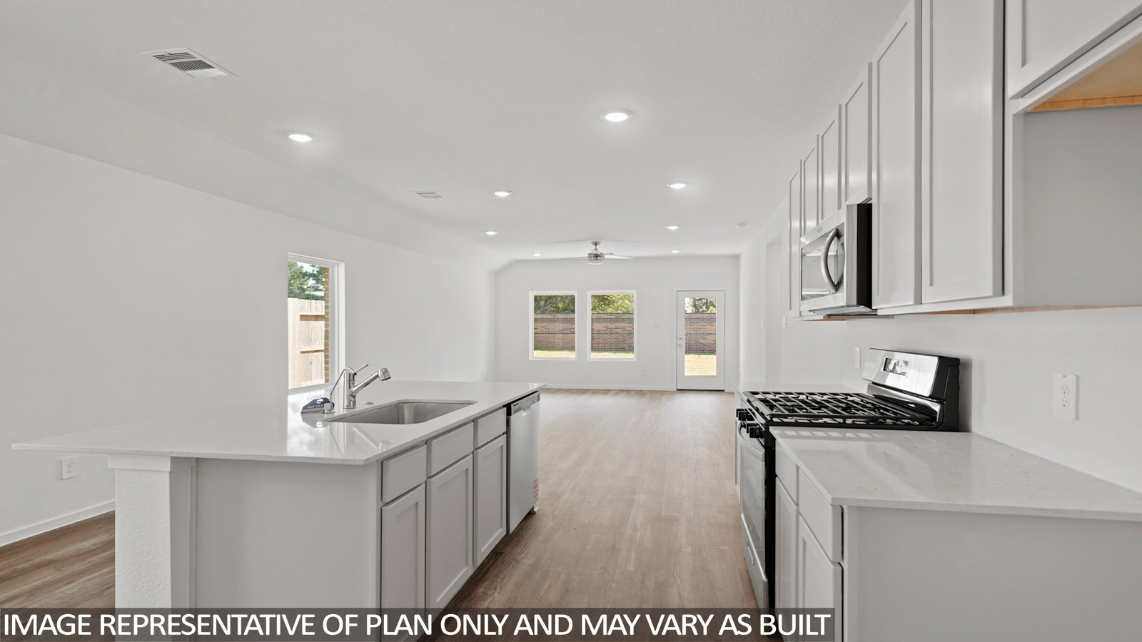 kitchen with stainless steel appliances, quartz countertops, and vinyl flooring