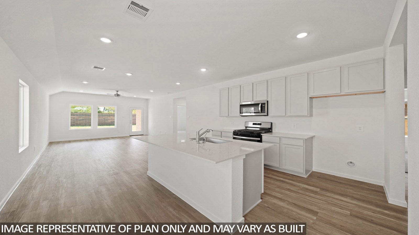 kitchen with stainless steel appliances, quartz countertops, and vinyl flooring