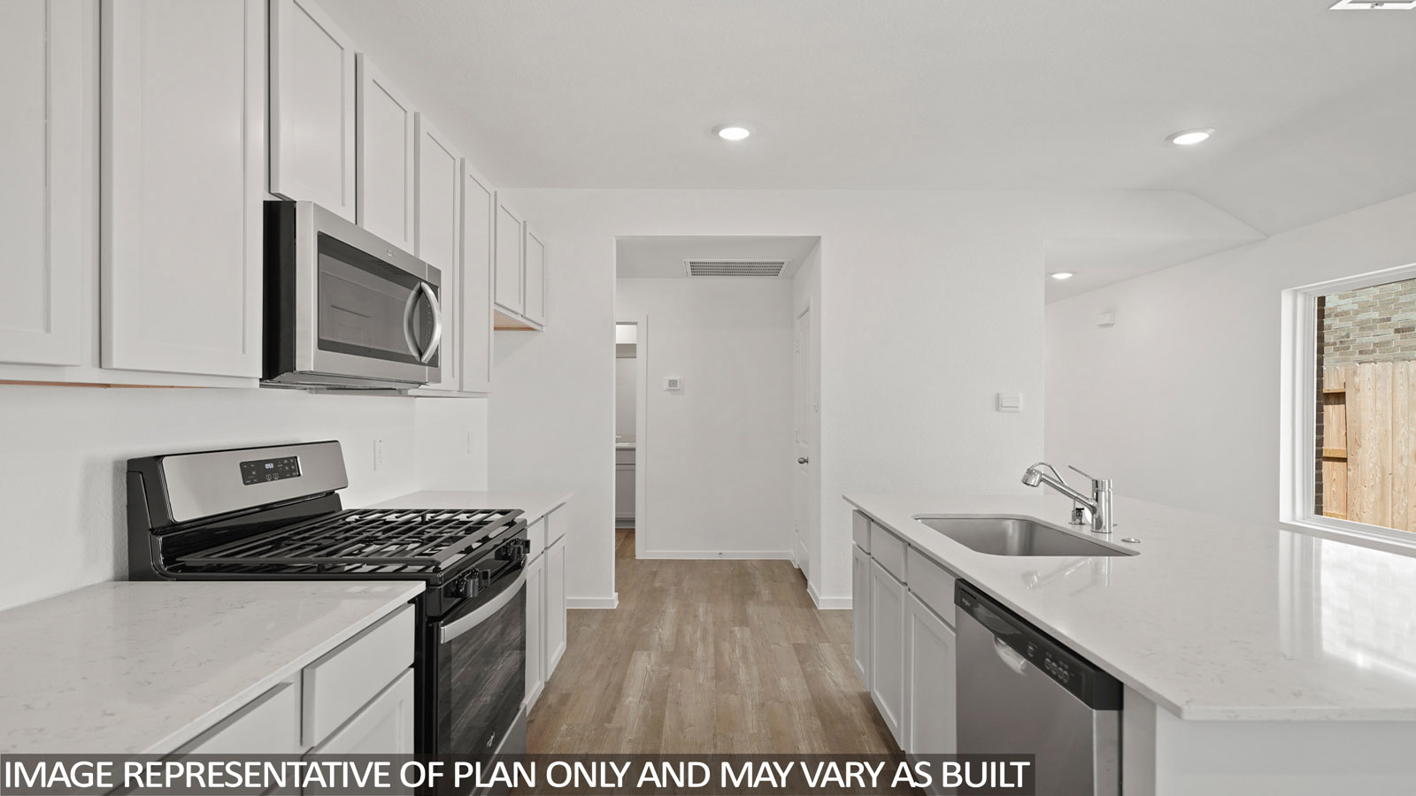 kitchen with stainless steel appliances, quartz countertops, and vinyl flooring