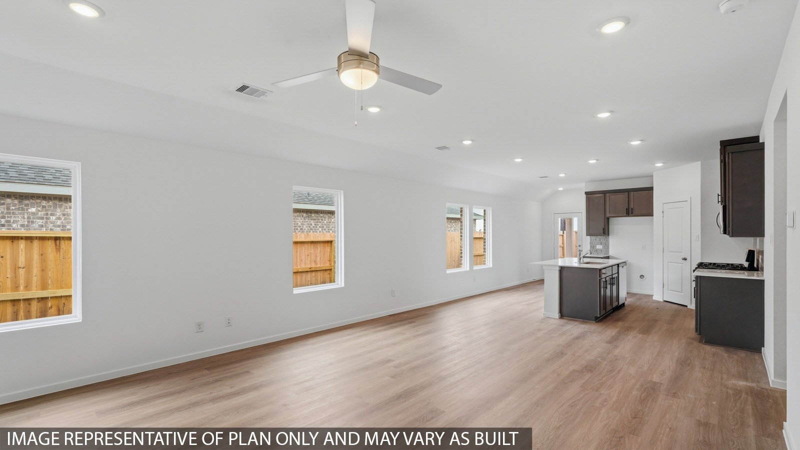 open concept living and dining area with vinyl flooring and large windows
