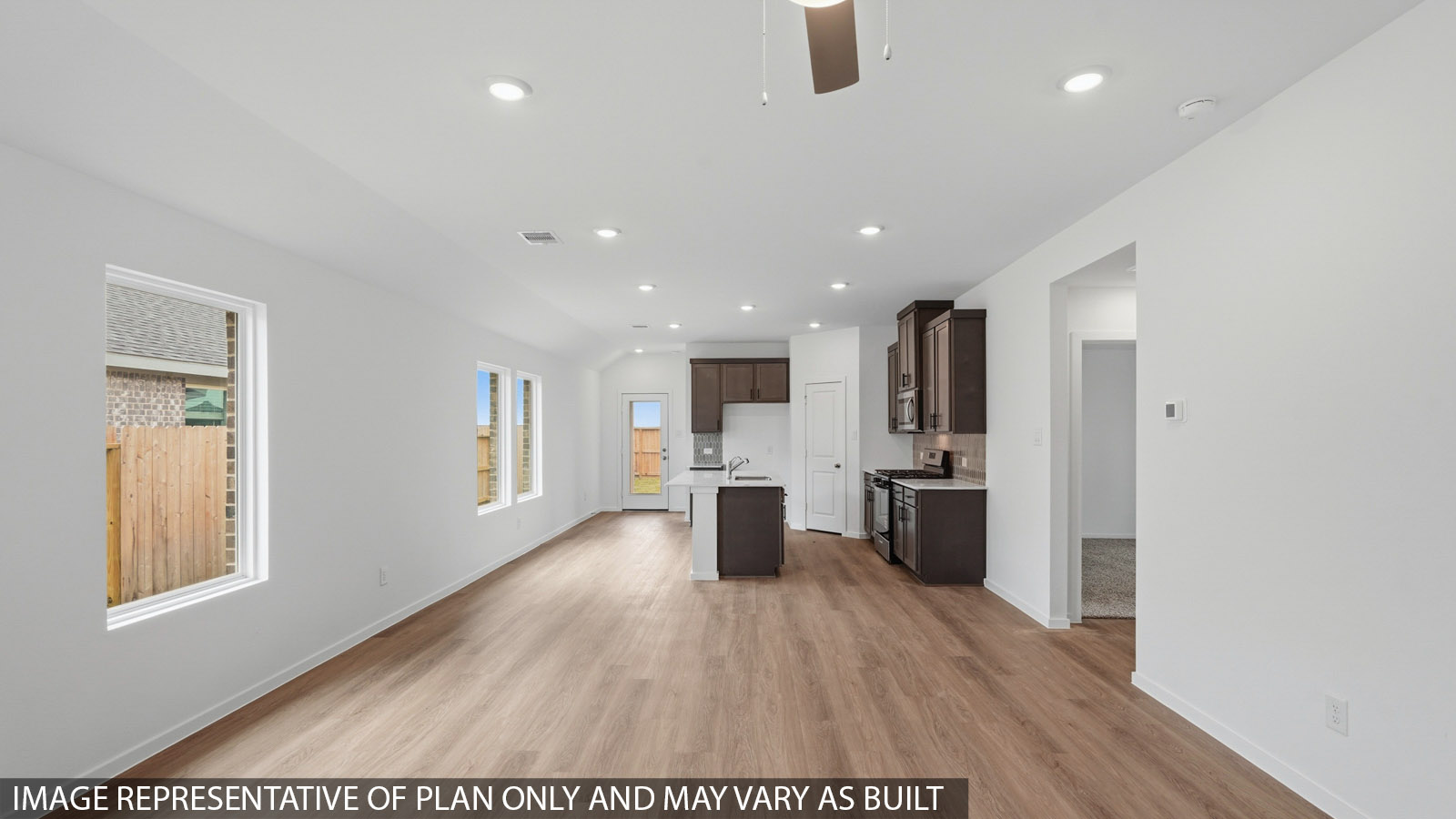 open concept living and dining area with vinyl flooring and large windows