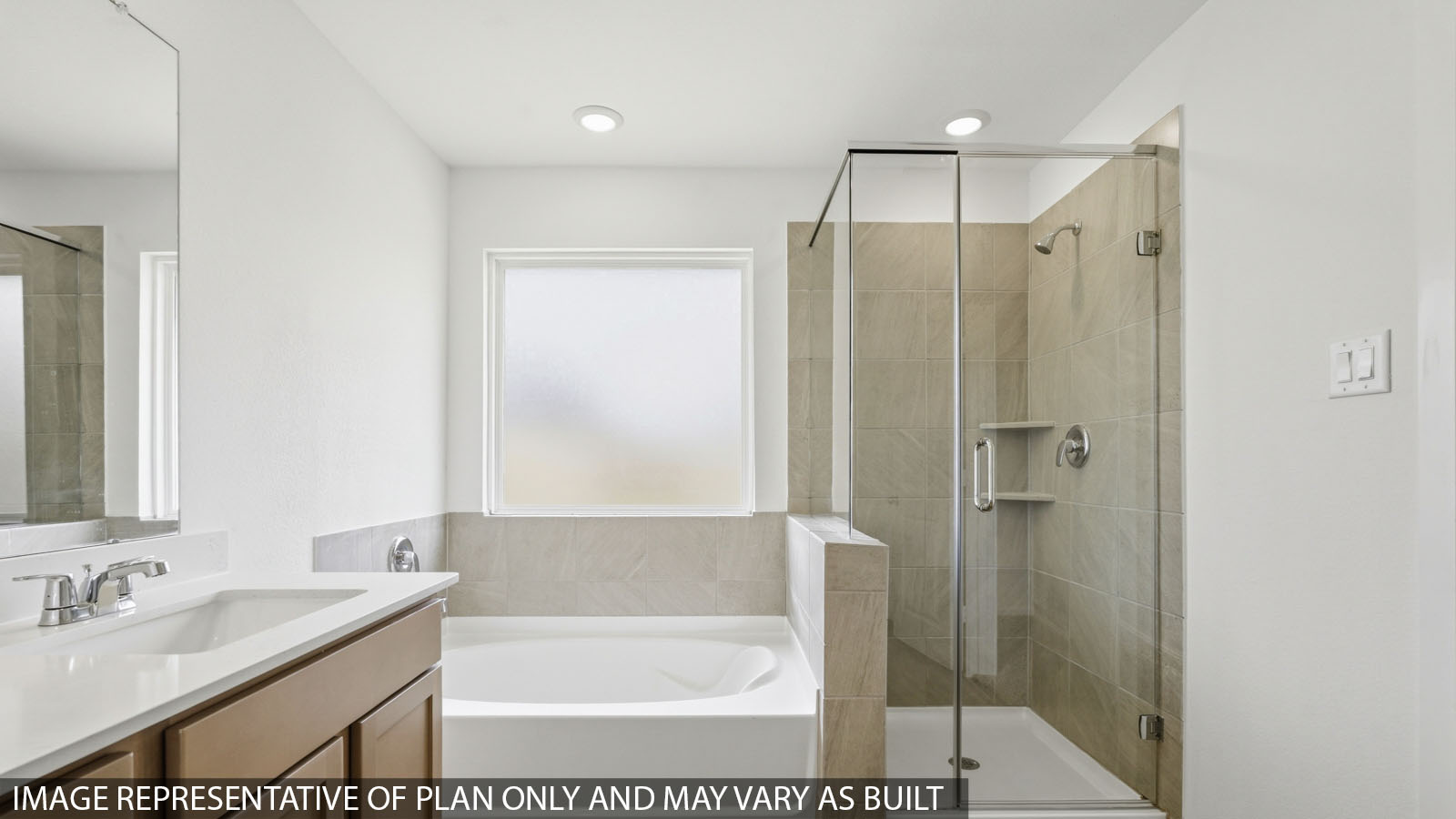 Primary bathroom with soaker tub and tile shower with semi frameless glass in Hockley TX