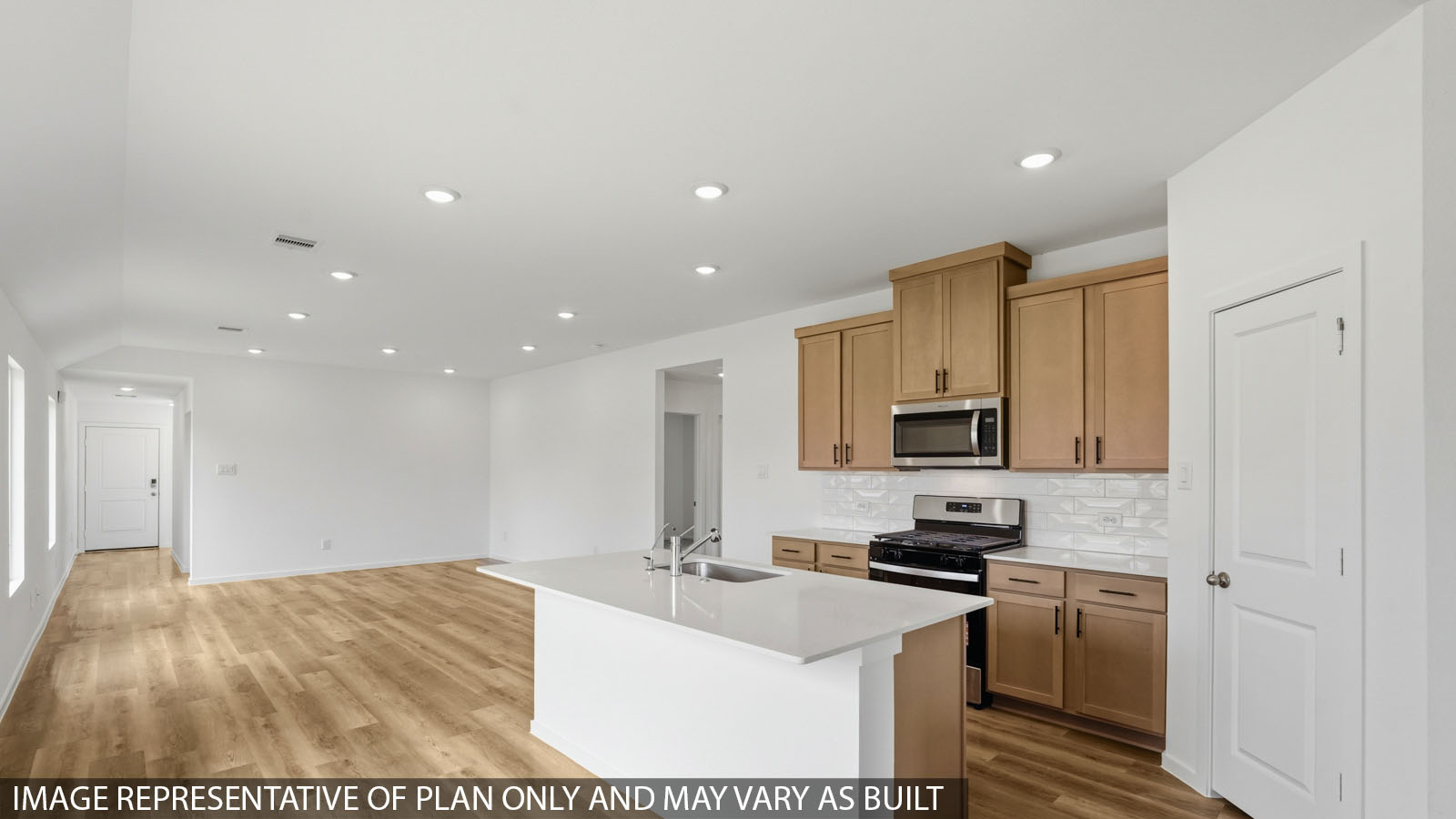 Kitchen with quartz countertops, modern hardware and an island and vinyl floor