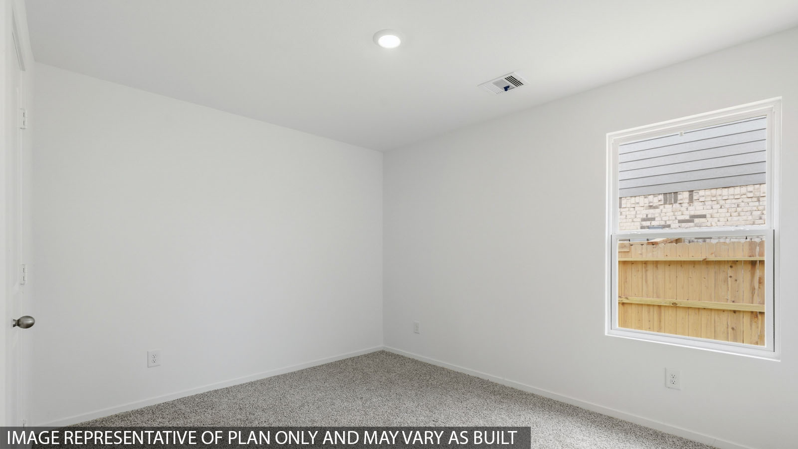 Secondary bedroom with shag carpet flooring and bright window