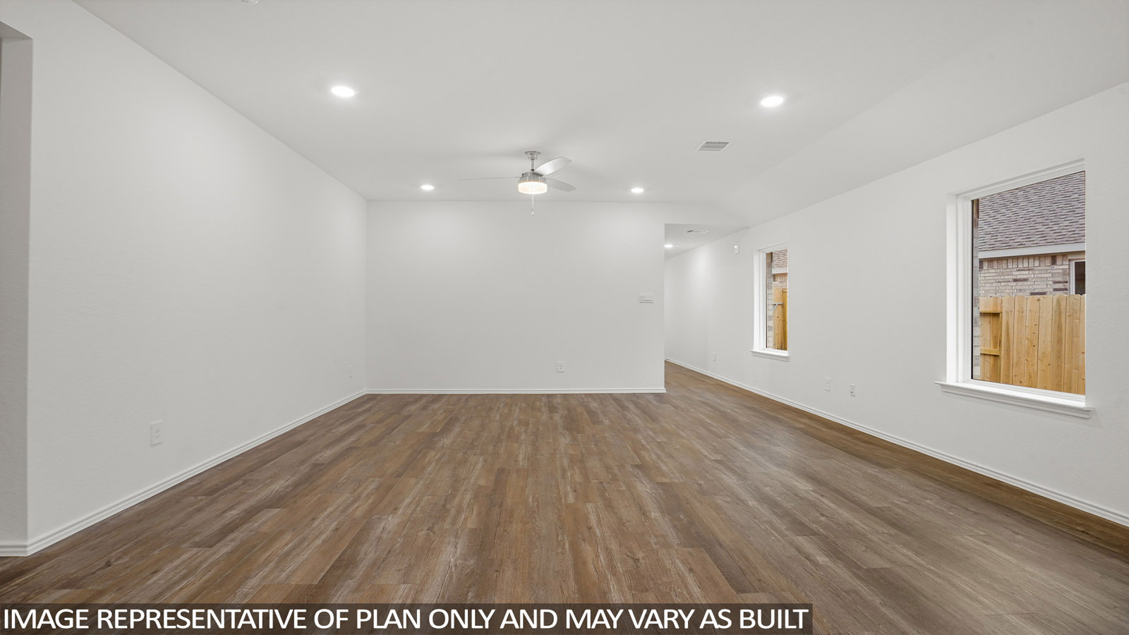 open concept living and dining area with vinyl flooring, large windows, and quartz countertops