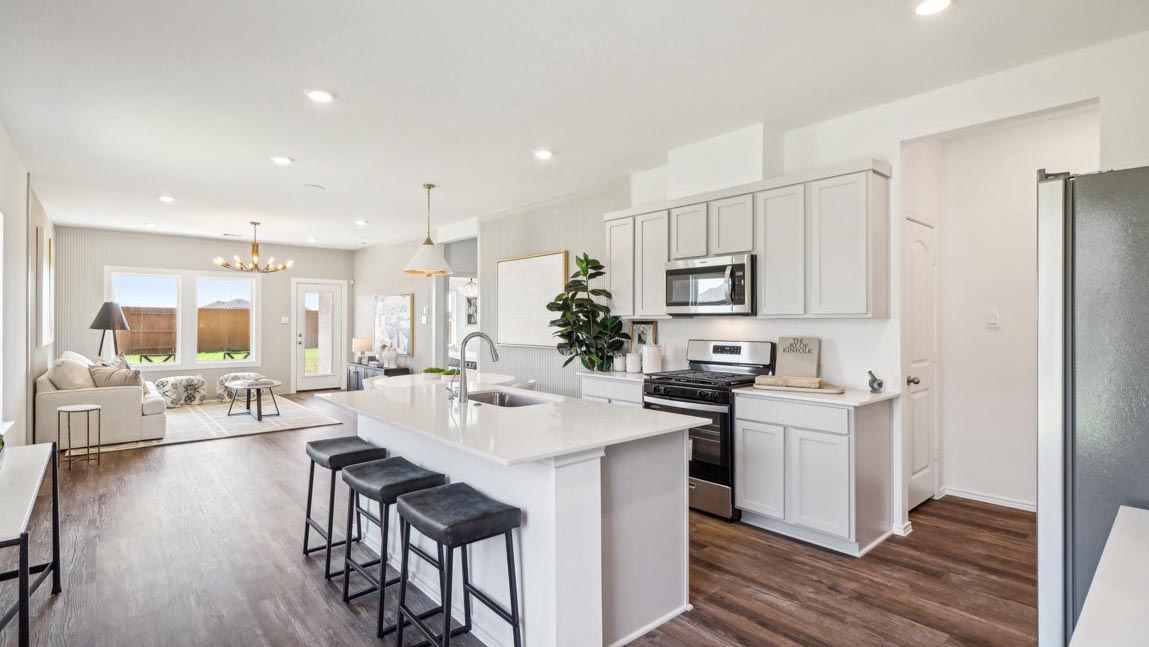 open concept living and dining area with vinyl flooring and quartz countertops