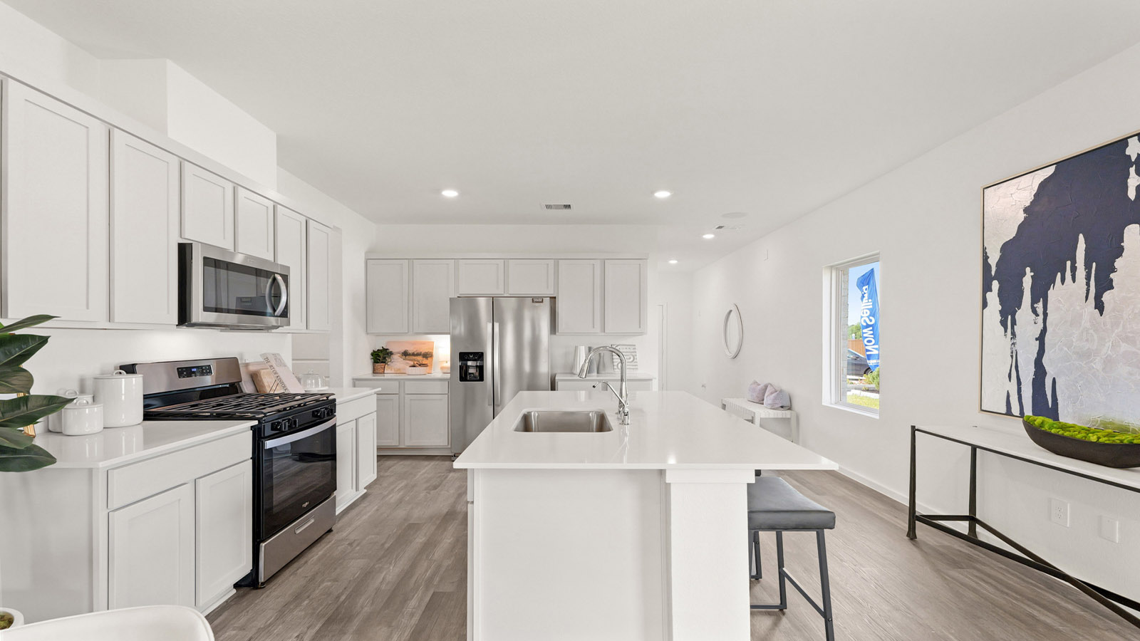 open concept living and dining area with vinyl flooring, quartz countertops, and large windows