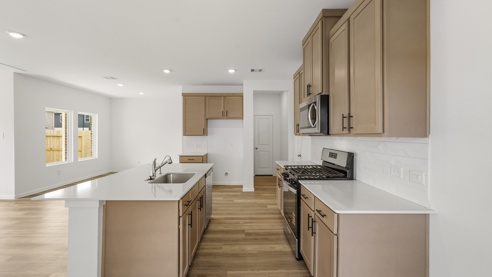 kitchen with stainless steel appliances and quartz countertops in Hockley, Tx