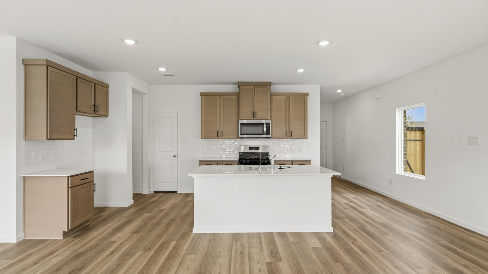 kitchen with stainless steel appliances and quartz countertops in Hockley, Tx