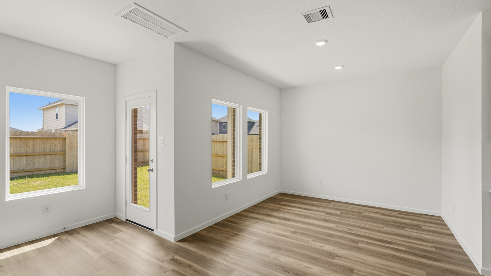 open concept living and dining area with quartz countertops, stainless steel appliances and vinyl flooring in Hockley, Tx