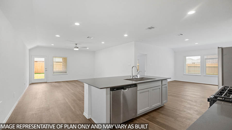 open concept living and dining area with vinyl flooring, quartz countertops, and stainless steel appliances