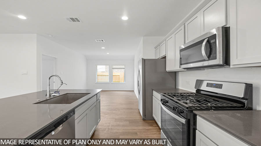 open concept living and dining area with vinyl flooring, quartz countertops, and stainless steel appliances