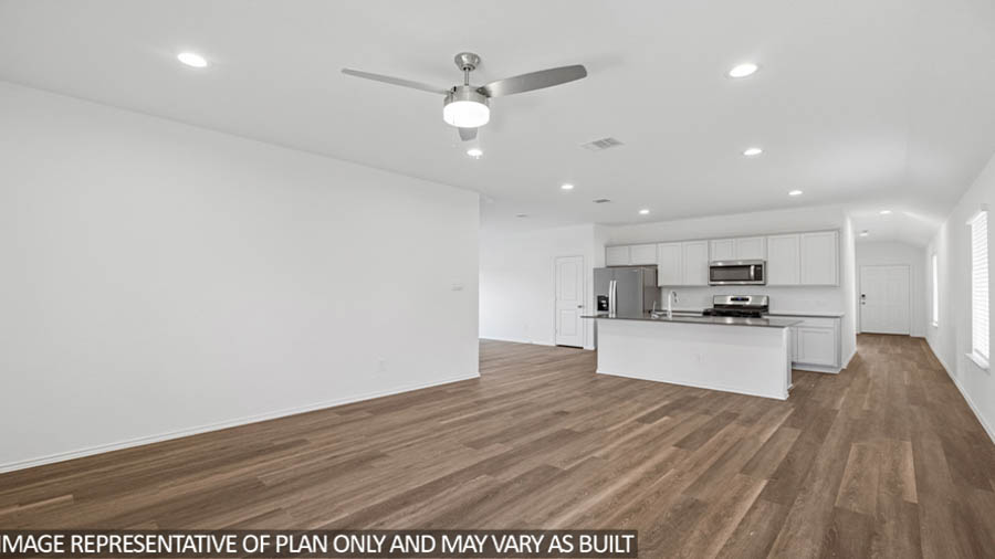 open concept living and dining area with vinyl flooring, quartz countertops, and stainless steel appliances