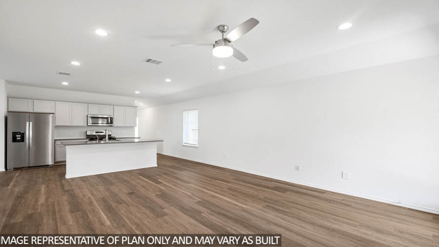 open concept living and dining area with vinyl flooring, quartz countertops, and stainless steel appliances