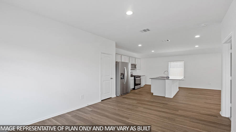 open concept living and dining area with vinyl flooring, quartz countertops, and stainless steel appliances