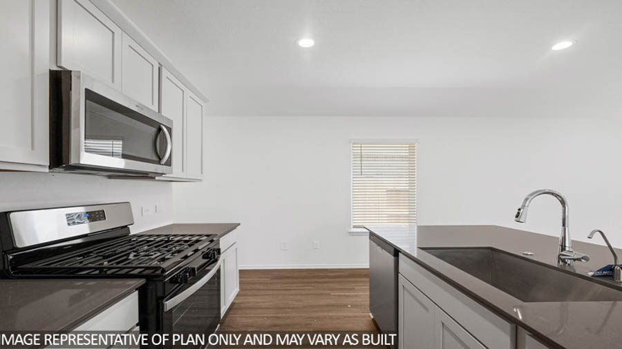 open concept living and dining area with vinyl flooring, quartz countertops, and stainless steel appliances