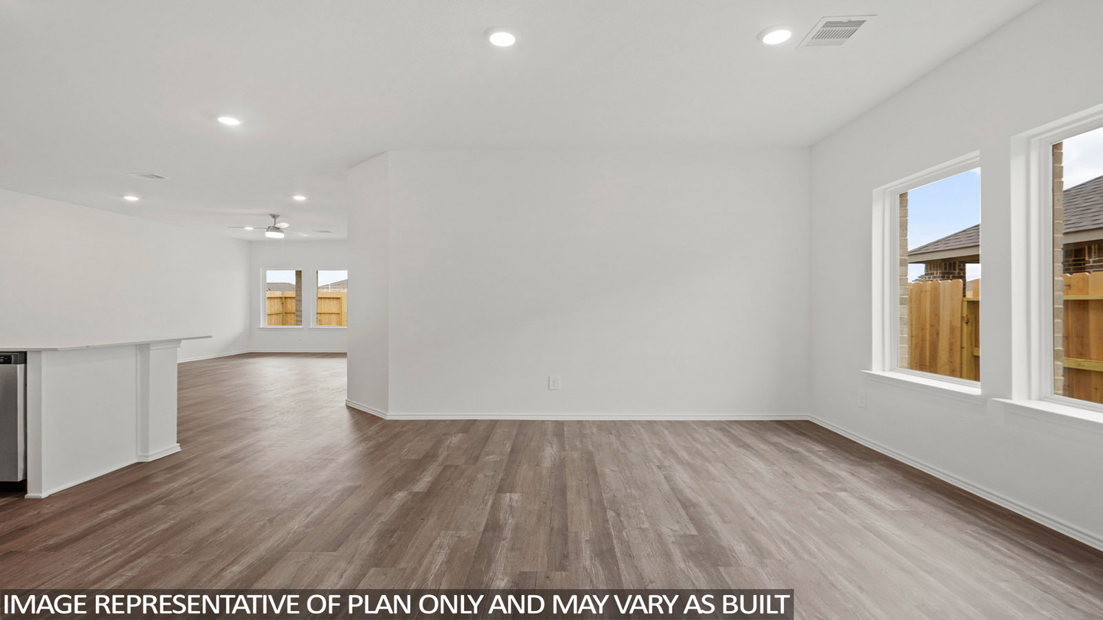 open concept livving and dining area with vinyl flooring, quartz countertops, and large windows