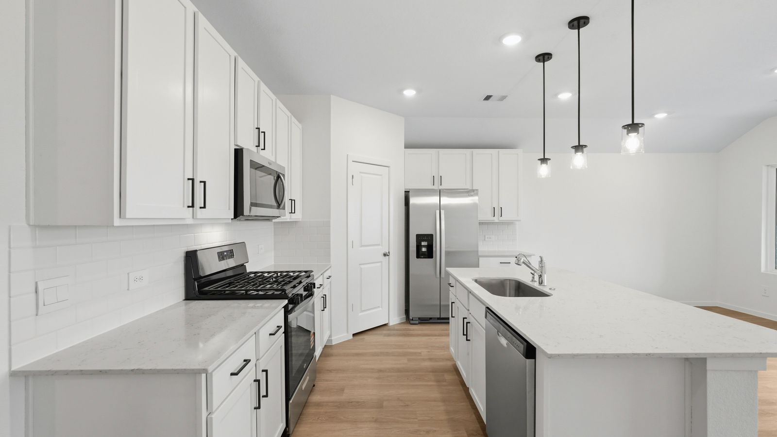 kitchen with pendent lighting, backsplash, and quartz countertops in Hockley, TX