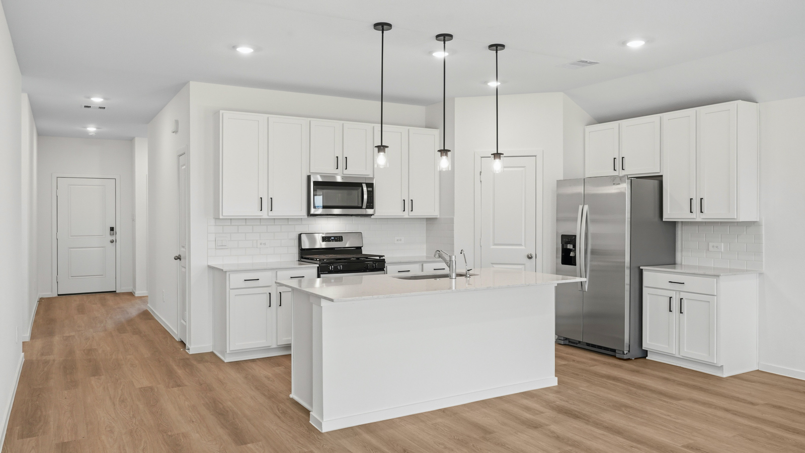 kitchen with pendent lighting, backsplash, and quartz countertops in Hockley, TX