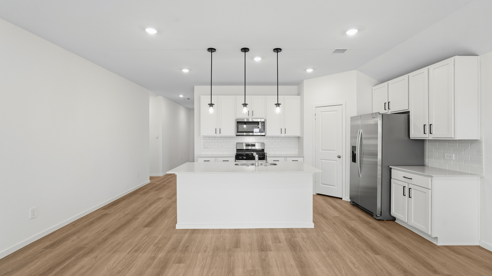 kitchen with pendent lighting, backsplash, and quartz countertops in Hockley, TX