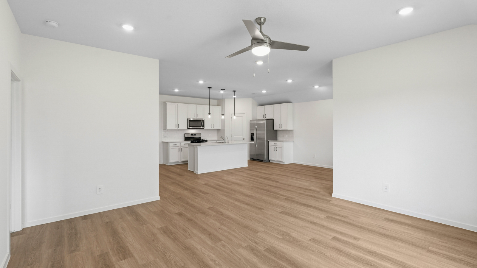 kitchen with pendent lighting, backsplash, and quartz countertops in Hockley, TX