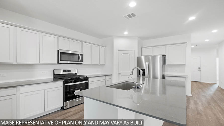 open concept living and dining area with vinyl flooring, large windows, and quartz countertops in Hockley, TX