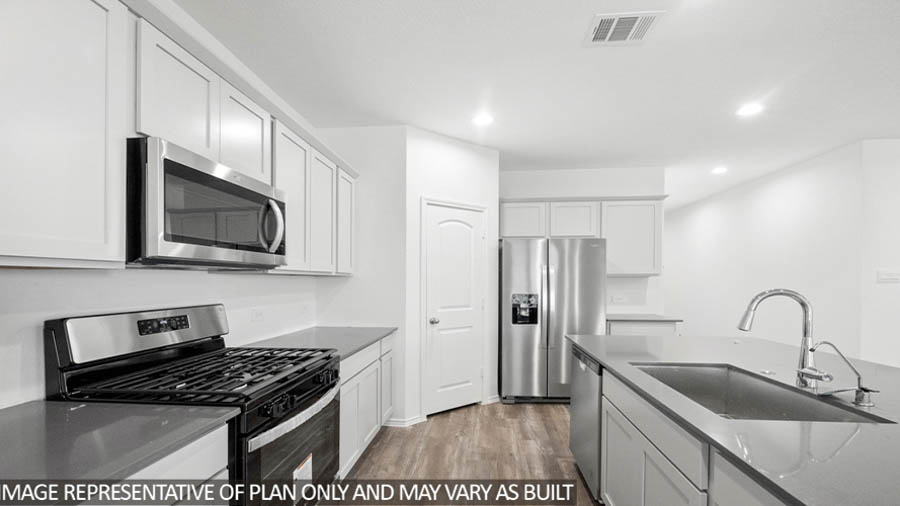 open concept living and dining area with vinyl flooring, large windows, and quartz countertops in Hockley, TX