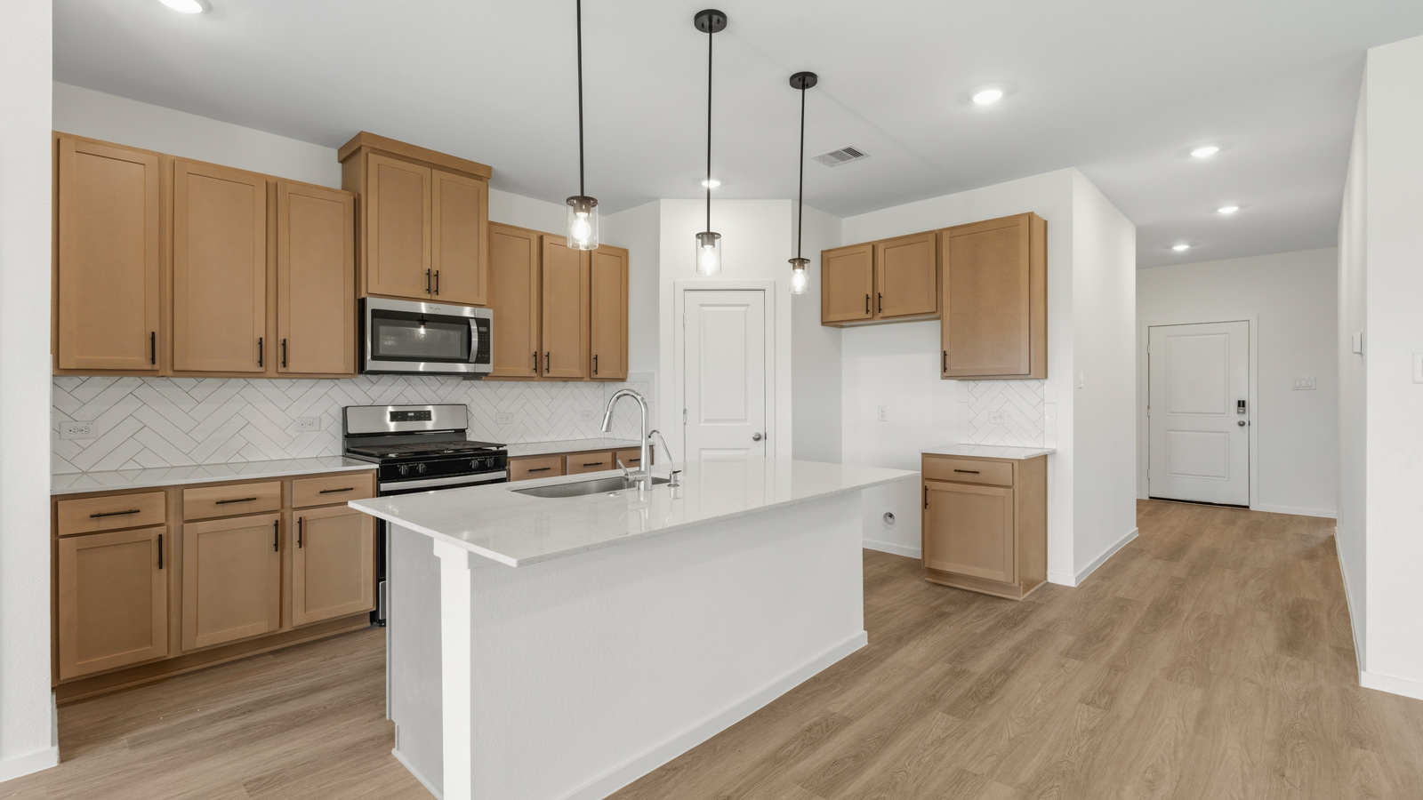 open concept living and dining area with vinyl flooring, quartz countertops, and stainless steel appliances
