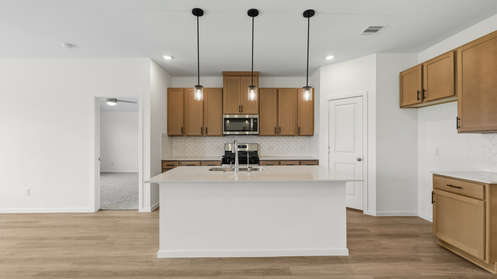 open concept living and dining area with vinyl flooring, quartz countertops, and stainless steel appliances