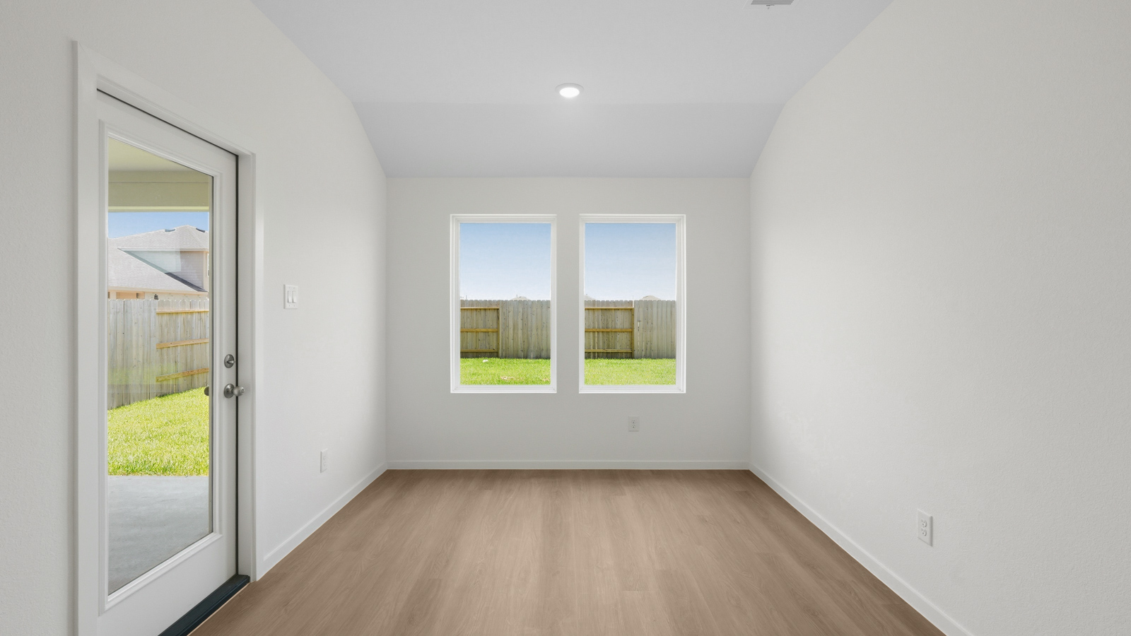 open concept living and dining area with vinyl flooring, quartz countertops, and stainless steel appliances