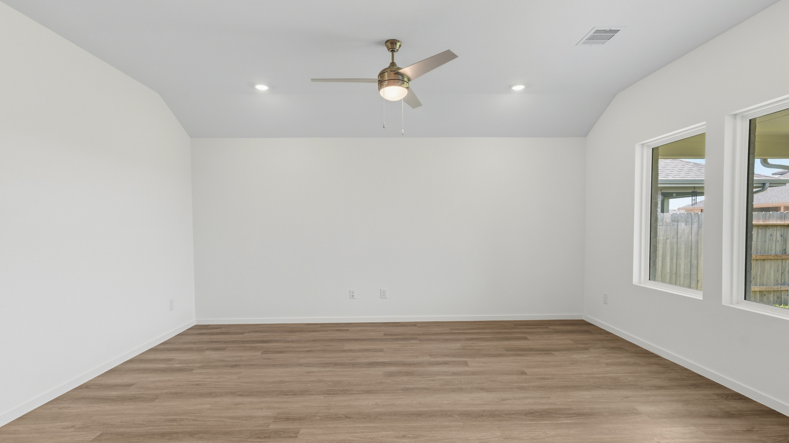 open concept living and dining area with vinyl flooring, quartz countertops, and stainless steel appliances
