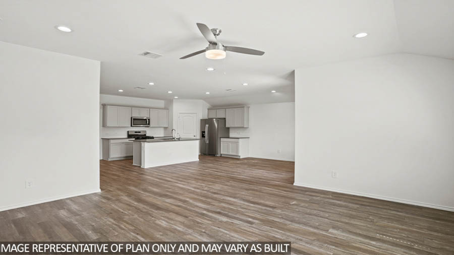 open concept livin area with vinyl flooring, large windows, and quartz countertops